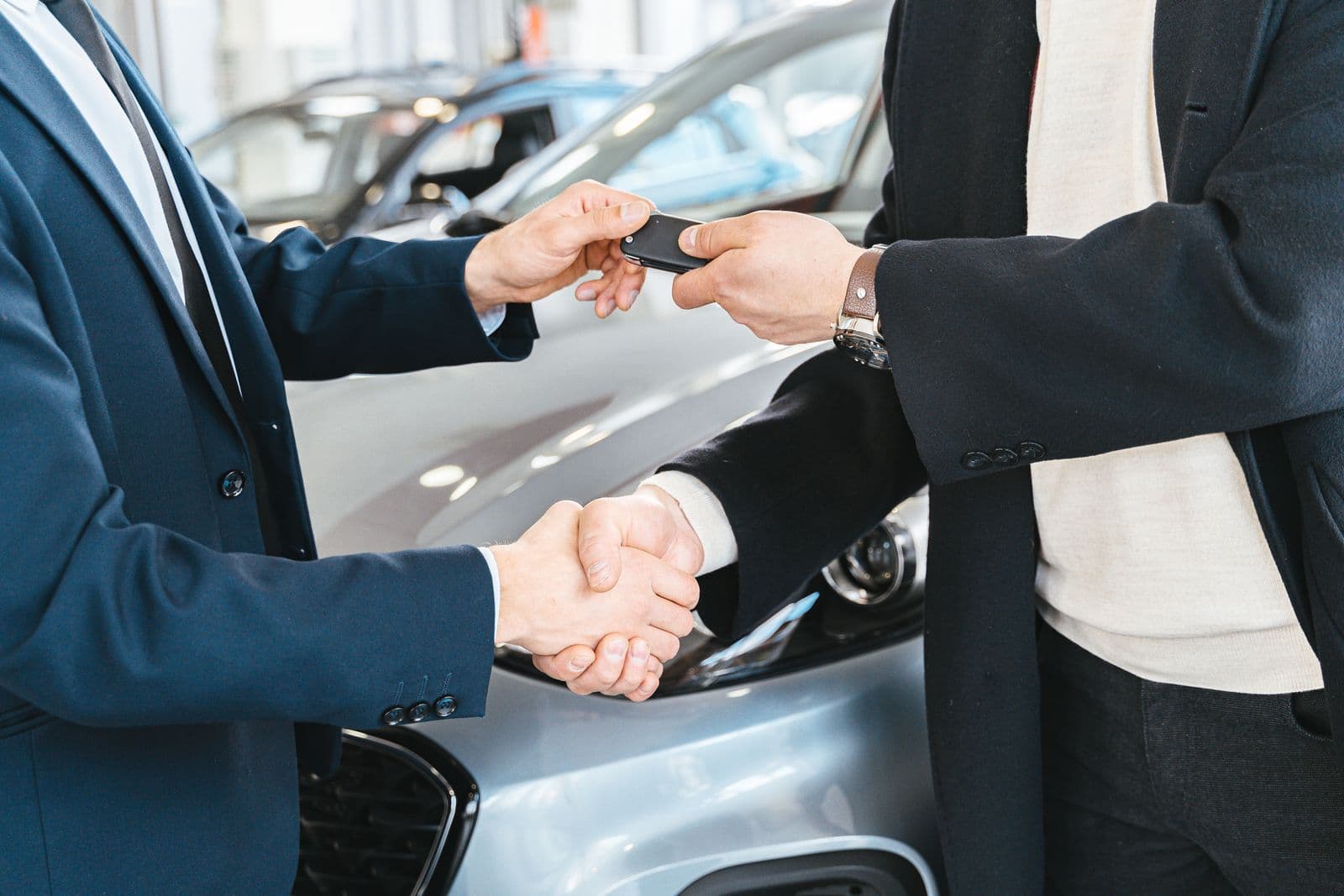 Sales consultant handing keys to a customer